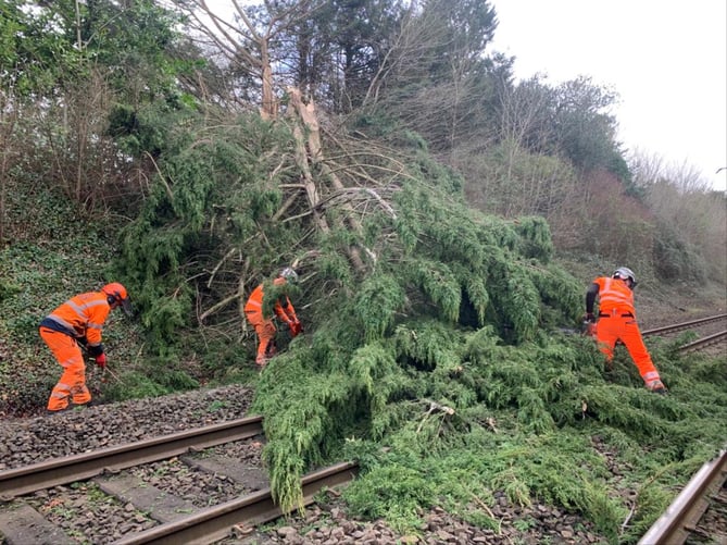 Network Rail is working to remove 30 collapsed trees - and a trampoline - from key routes on its network