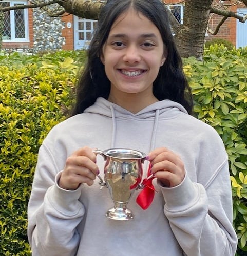 Four Marks singer Jaya Passingham, 14, with The Rowland Owen Trophy which she won for singing at the Godalming Music Festival in March 2022.