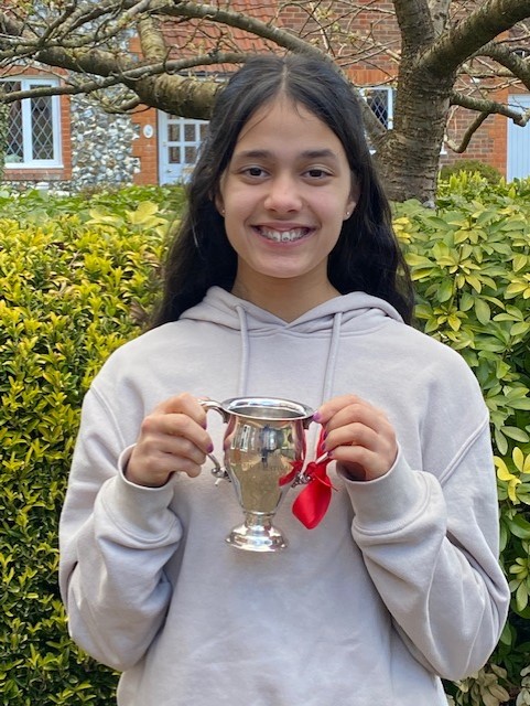 Four Marks singer Jaya Passingham, 14, with The Rowland Owen Trophy which she won for singing at the Godalming Music Festival in March 2022.