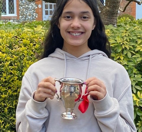 Four Marks singer Jaya Passingham, 14, with The Rowland Owen Trophy which she won for singing at the Godalming Music Festival in March 2022.