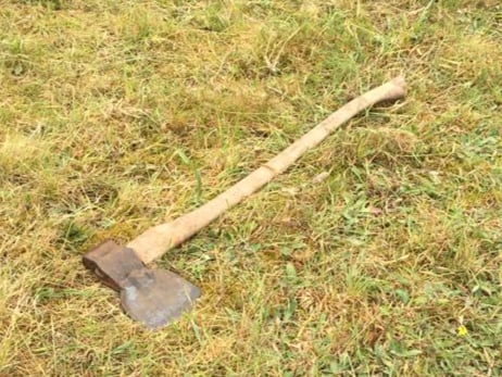 An discarded axe, used to shop up firewood in the woodland bordering Shortfield Common, Frensham, a protected Site of Special Scientific Interest, by travellers encamped on the site
