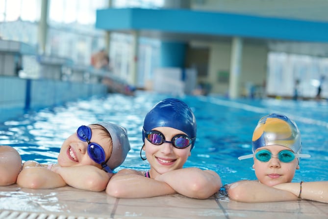 Stock picture of swimmers in pool.