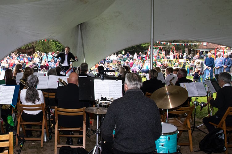 The Alton Concert Band, conducted by Jeremy Morrish, plays to the crowd in Alton’s Public Gardens at The Big Lunch for the Queen’s Platinum Jubilee on June 5th 2022.