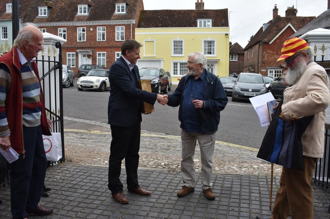 Winchester and Chandler’s Ford MP Steve Brine presents Bernard Tucker with a gift in Alresford
