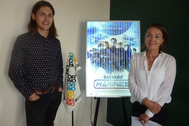 James Nash and Sarah Baker with a poster which Black Hangar Studios created on 35mm film strips.