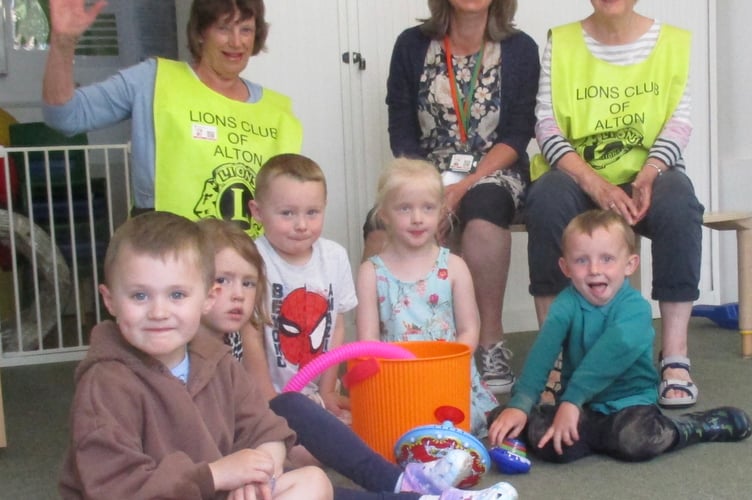Alton Lions Club members Moira Baker, left, and Sarah O’Donoghue with children and interim headteacher Helen Porter at Bushy Leaze Children and Families Centre in Alton.