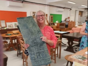 Karen, the first customer at the larger Resurrection Furniture shop in Alton High Street, takes home the rug she bought on July 12th 2022.