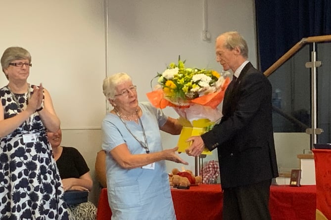 Hampshire county councillor Mark Kemp-Gee presents flowers to Jean Cornelius to mark her retirement as a local authority governor at St Mary’s Bentworth CE Primary School, July 20th 2022.