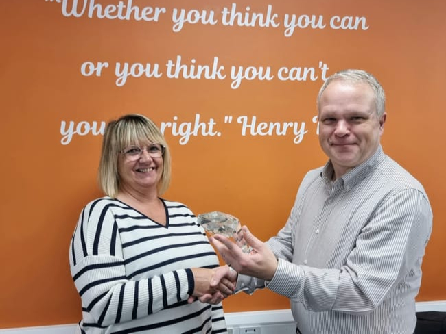 Sara Woodley receives her award from Simon Osborne