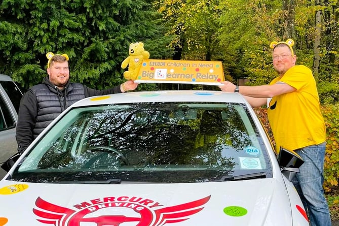 Barry Davis, of Basingstoke, receives the sign at the start of his Big Learner Relay leg from Jamie Johnson, of Petersfield, November 16th 2022.