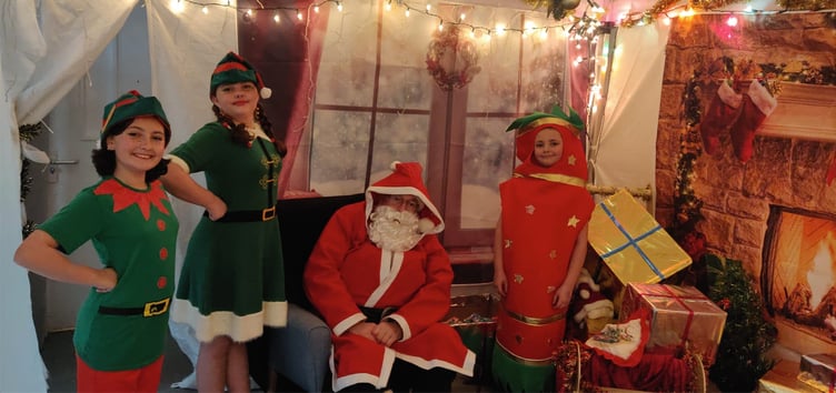 Father Christmas, elves Jingle and Jangle and the Christmas Cracker in Santa's Grotto at Alton Community Association's Christmas Cracker Fair, Alton Community Centre, December 3rd 2022.