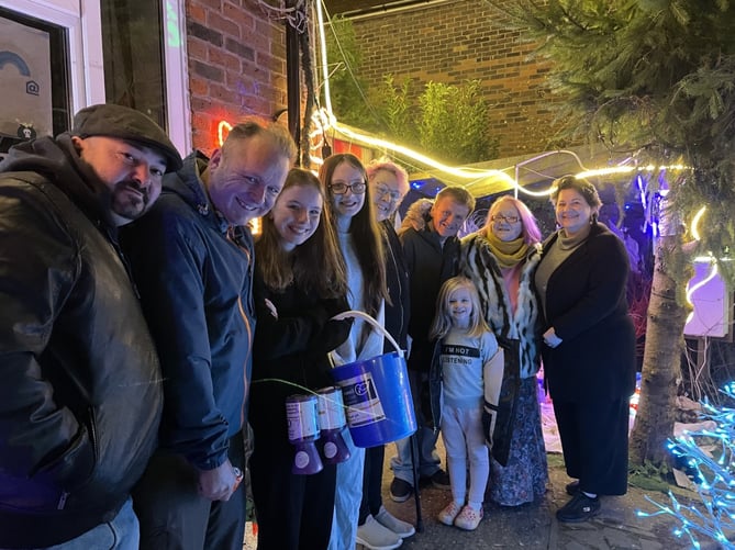Katie Deak (right) donated £400 to Gail Whattingham (second right) to save Farnham’s ‘Christmas House’
