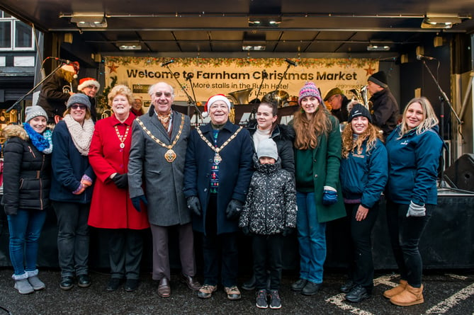 Town mayor Alan Earwaker (centre) with borough mayor John Ward and sponsors at this month’s Farnham Christmas Market