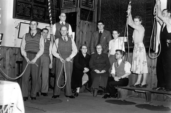 The 1951 team poised to start the midnight peel in the Farnham ringing loft in a photograph from the Herald negative archive held at the Museum of Farnham