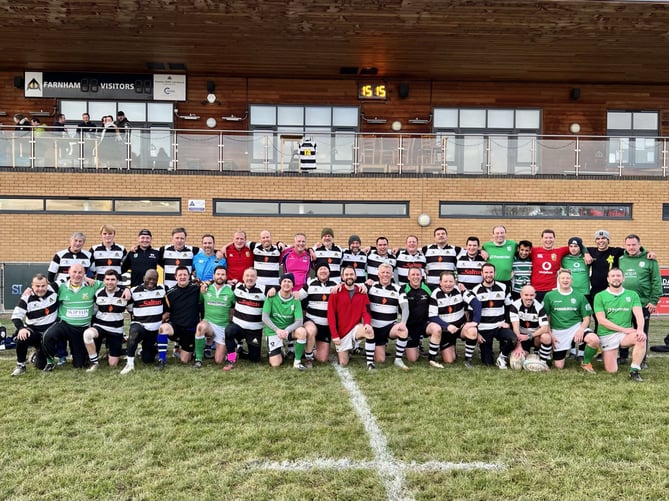 Farnham and London Irish Vets line up after their match beneath Adrian Myers’ No14 shirt