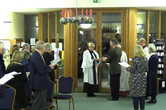 New vicar of The Bourne Revd Sandy Clarke is ceremonially handed the keys to the churches