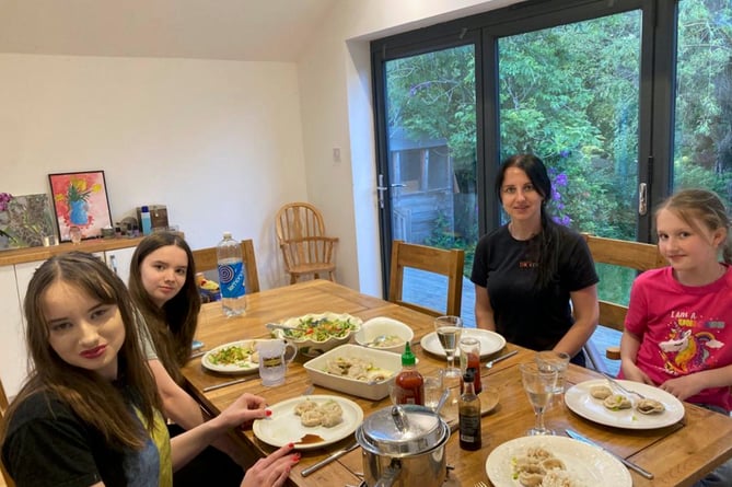 Ella (left) with her sister Poppy and the Ukrainian family, mother Ksenia and daughter Veronika, who came to live with them