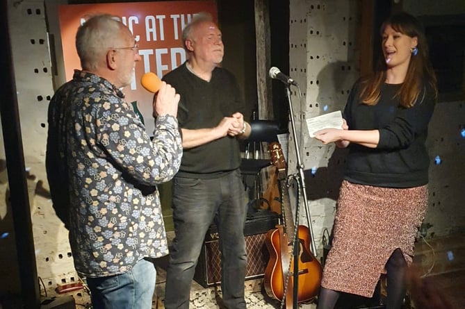 Music at the Pottery co-organisers Peter Crutchfield and Jim Cozens present a cheque for £2,120 to Creative Response chief executive Kathryn McManus at The Farnham Pottery in Wrecclesham on December 17th 2022.