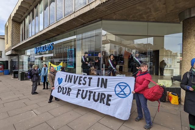 Extinction Rebellion ‘suffragettes’ chain themselves in Guildford bank