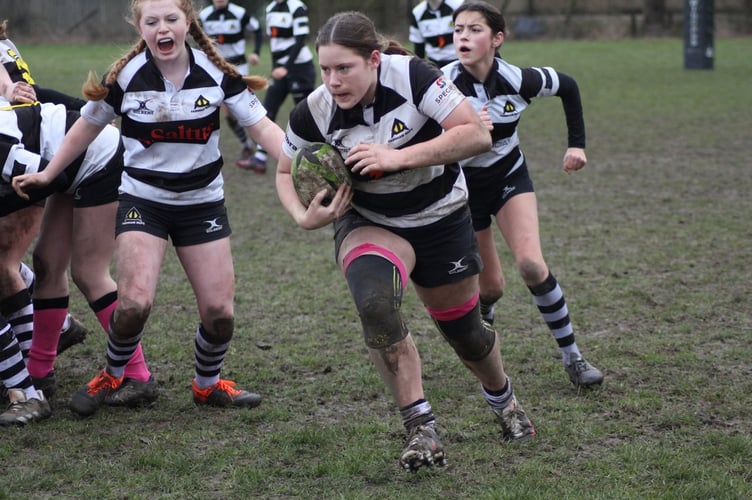 Under-14 skipper Hattie Gibbon picks up from the base and is on the charge