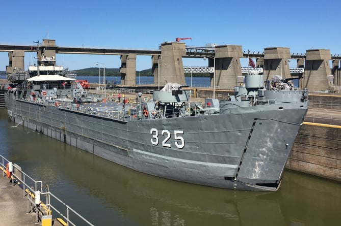 The USS LST-325 passes through Smithland Locks and Dam on the Ohio River at Brookport, Illinois. LST-325 is a decommissioned tank landing ship of the United States Navy, now docked in Evansville, Indiana. 