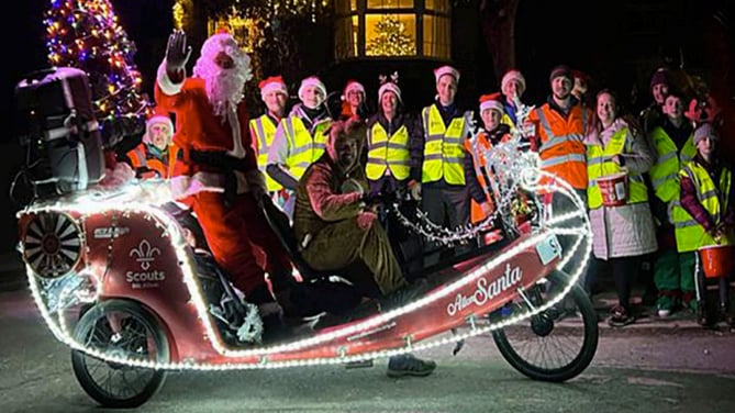 Santa on his eco sleigh with Alton Round Table and 8th Alton Scout Group members, December 2022.