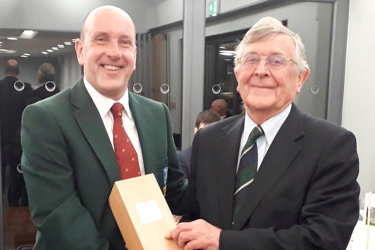 Alresford captain Simon Freemantle (left) presents David Harrison with a 50-year-old bottle of vintage port to mark the 50th year of Hampshire playing against Alresford since 1971 after David founded the fixture after he became county captain. COPYRIGHT HAMPSHIRE GOLF. NOT FOR SYNDICATION. FREE to use in reports in print and online of Hampshire Golf matches and championships ONLY.