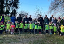 Young and old plant trees in Shalden to remember the Queen