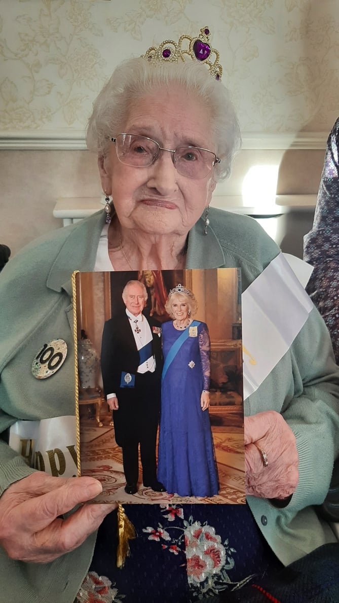 100-year-old Doris Beryl Pharo with her card from the King and Queen Consort