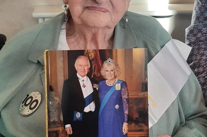 100-year-old Doris Beryl Pharo with her card from the King and Queen Consort