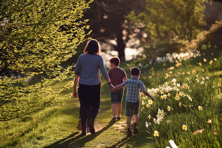 Visitors in the garden in spring at Killerton, Devon.