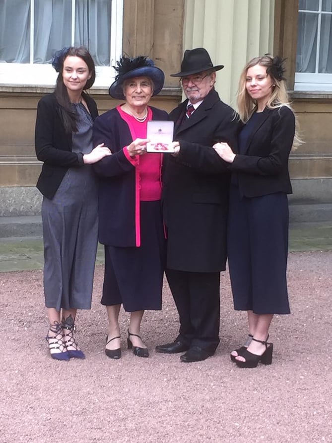 Janet Maines MBE with partner Victor and granddaughters Talor (left) and Roxanne at Buckingham Palace