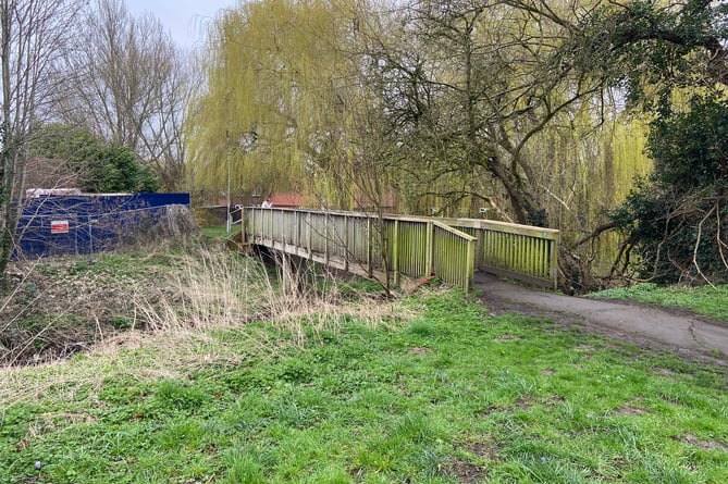 The wooden footbridge across the River Wey by the 40 Degreez youth centre, which councillor Andy MacLeod acknowledged is in a 'shocking condition'