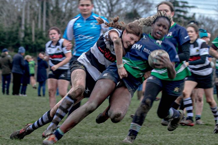 A flying tackle halts an Old Reigatians attack