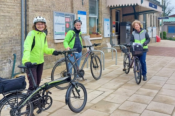 Chris Chappell and Janice Montgomerie from Cycle Alton at Alton station with Ben Kennedy of Hampshire County Council, April 2023.