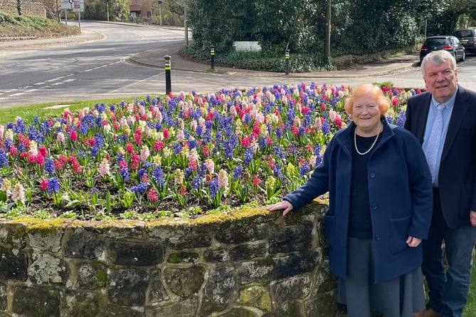 Councillors Angela Glass and Bill Mouland next to Liphook’s new red, white and blue coronation flower bed