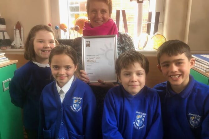 Camelsdale School RE subject leader Lindsay Russell and pupils with the school’s new certificate