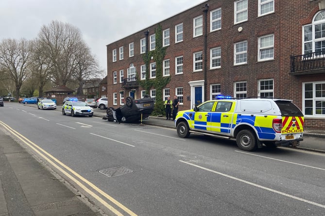 Three police cars were still at the scene of the three car smash in The Hart, Farnham, at around 2pm on Thursday, April 27, waiting for a recovery vehicle