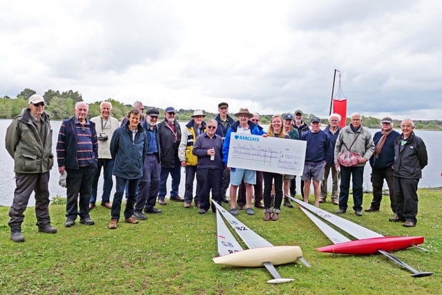 Frensham Pond Sailing Club's Radio Sailing Group hands over a cheque to Shooting Star Chase children's hospice