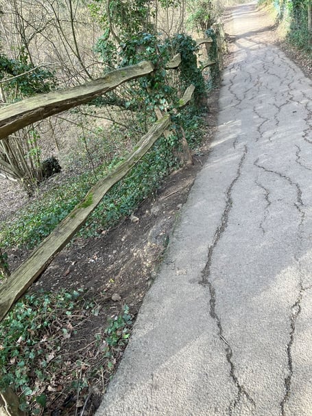 A section of the diagonal path across Farnham Park is slowly disappearing into a sinkhole