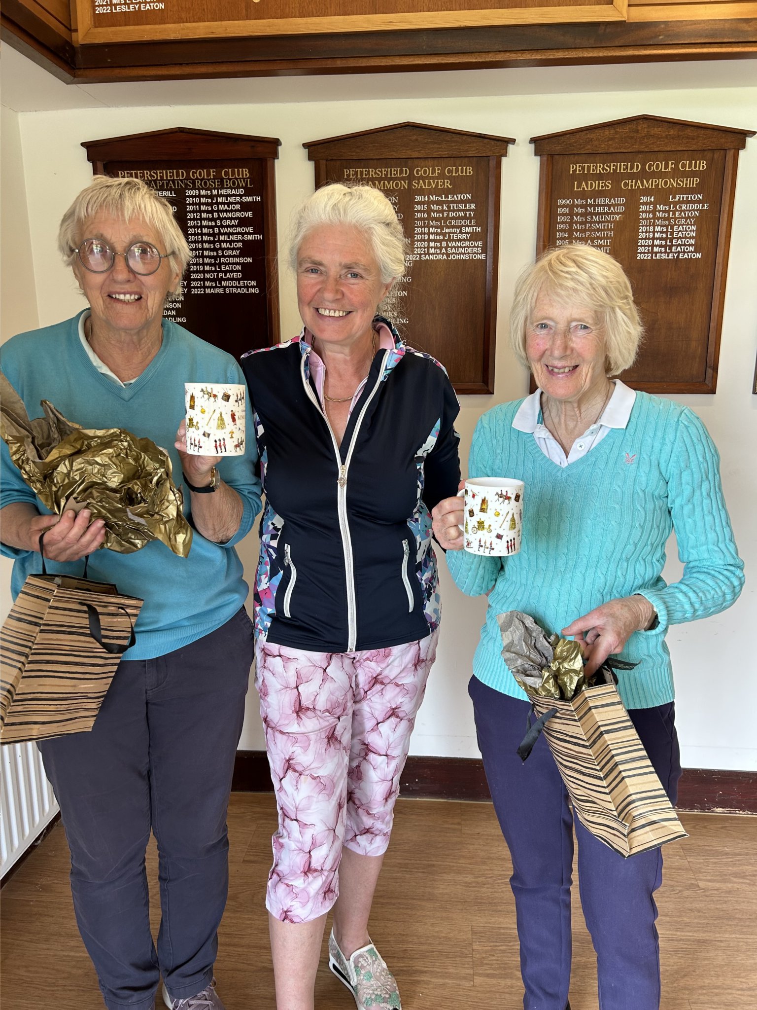 Winners Sue Gray (left) and Claire Powell (right) receive their King Charles III competition prizes from Jennifer Neal