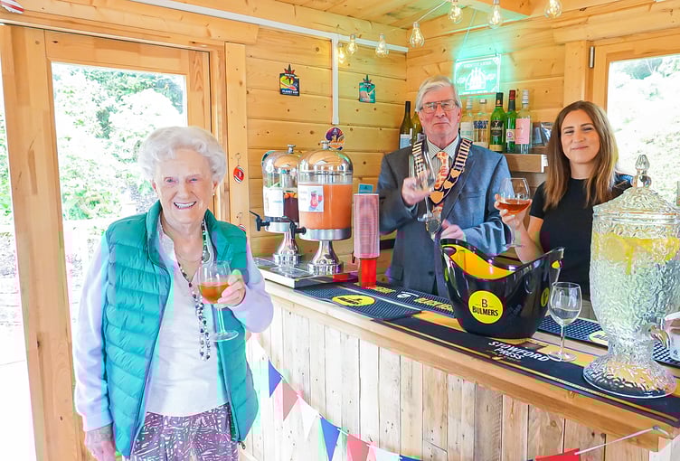 Resident Joyce Douglas enjoying The Redcot Arms’ first drink, served by town mayor Jerome Davidson