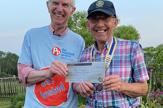 Former president of Haslemere Rotary Cub, Paul Mills, presents David Whitby from the Guildford Prostate Cancer Charity £4,000 cheque