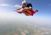 Ninety-year-old former Royal Navy commander raises £21,000 skydiving