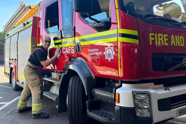 Fireman washing fire engine.