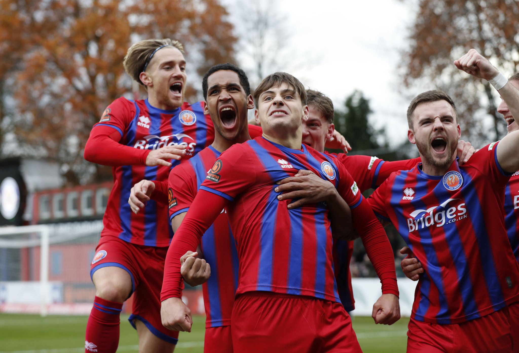 Josh Stokes celebrates with his team-mates after giving Aldershot Town an early lead against Stockport County