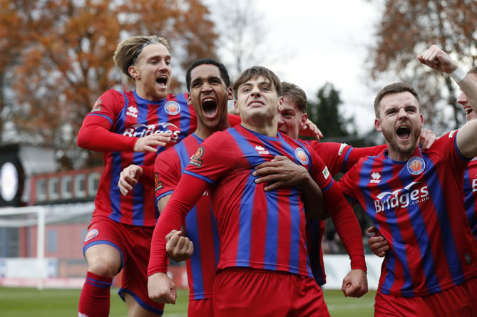 Josh Stokes celebrates with his team-mates after giving Aldershot Town an early lead against Stockport County