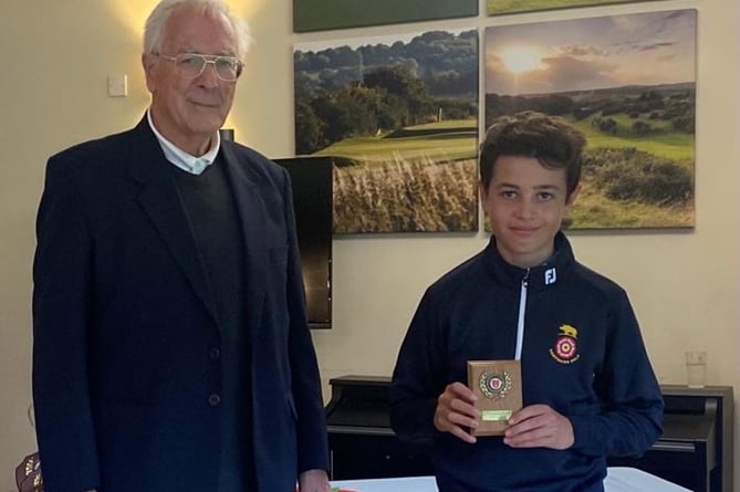 Ollie McDonald receives his prize from Frank Hayward at Hockley Golf Club