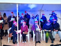 Festive joy for Bordon group on choir's debut at Grayshott light event