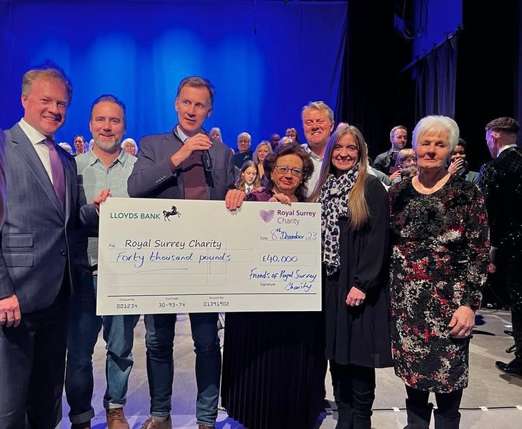 Chancellor Jeremy Hunt hands over a cheque for £40,000 to the Royal Surrey Charity towards the hospital's new cancer and surgical innovation centre